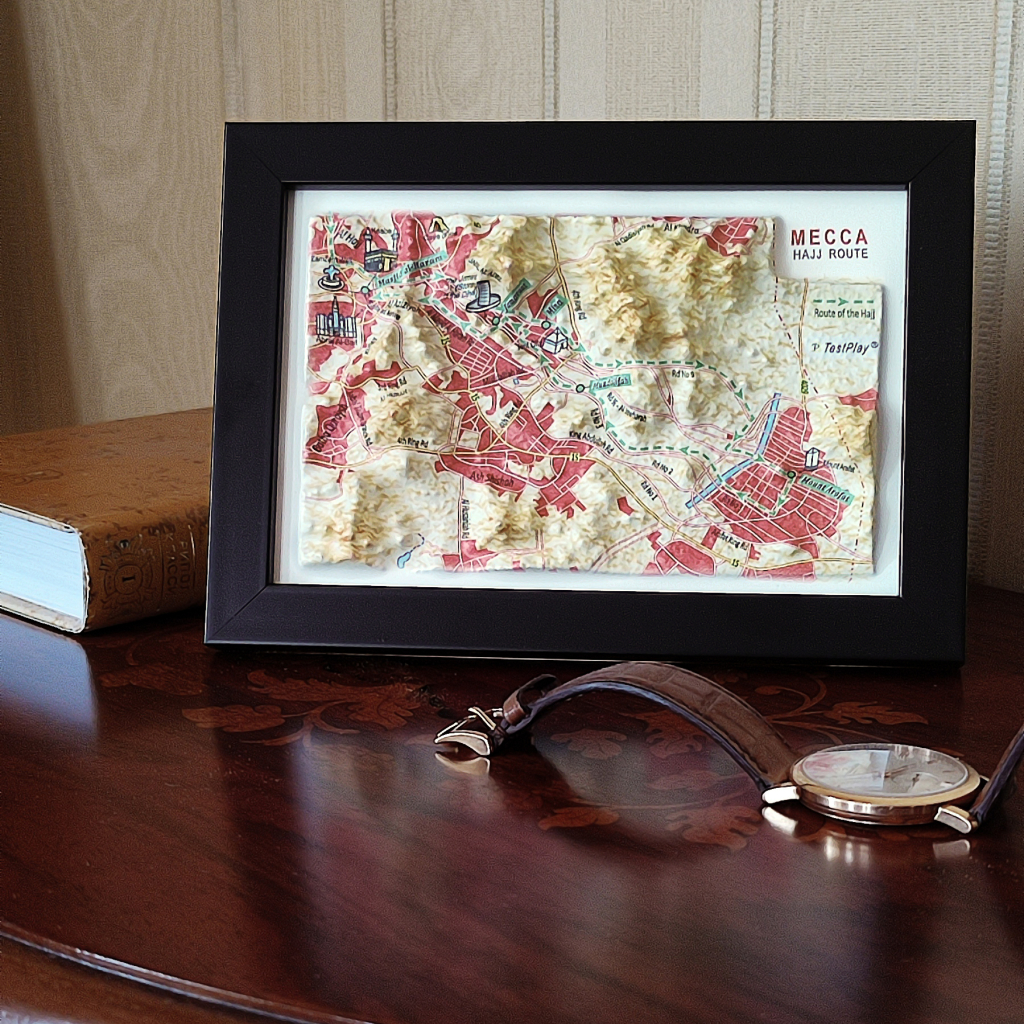 Mecca Saudi Arabia 3D map framed on desk with luxury watch and book